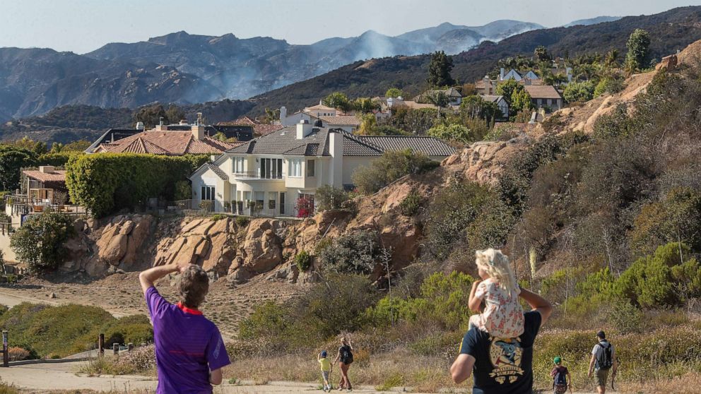 PHOTO: A brush fire burns near homes in the Highlands community of Pacific Palisades in California, as viewed from a fire road, May 17, 2021.