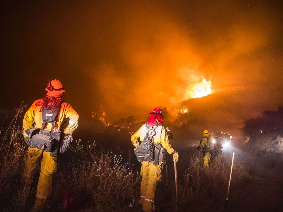 PHOTO: Firefighters watch for embers crossing over the road early Thursday morning, Dec. 14, 2017 at the Thomas Fire during a firing operation in the hills above Los Padres National Forest, Calif. 

