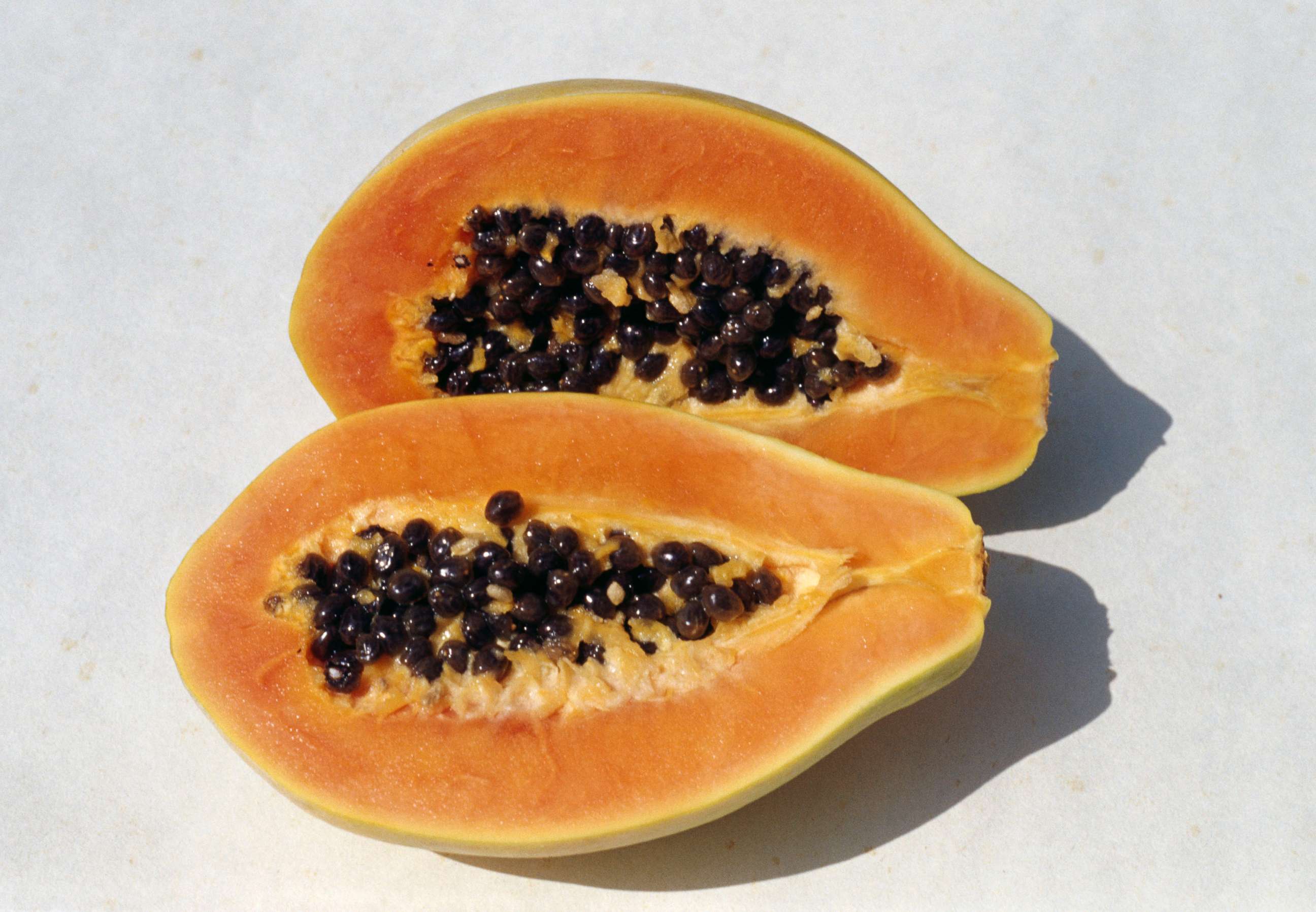 PHOTO: A papaya is shown cut into cross-sections.