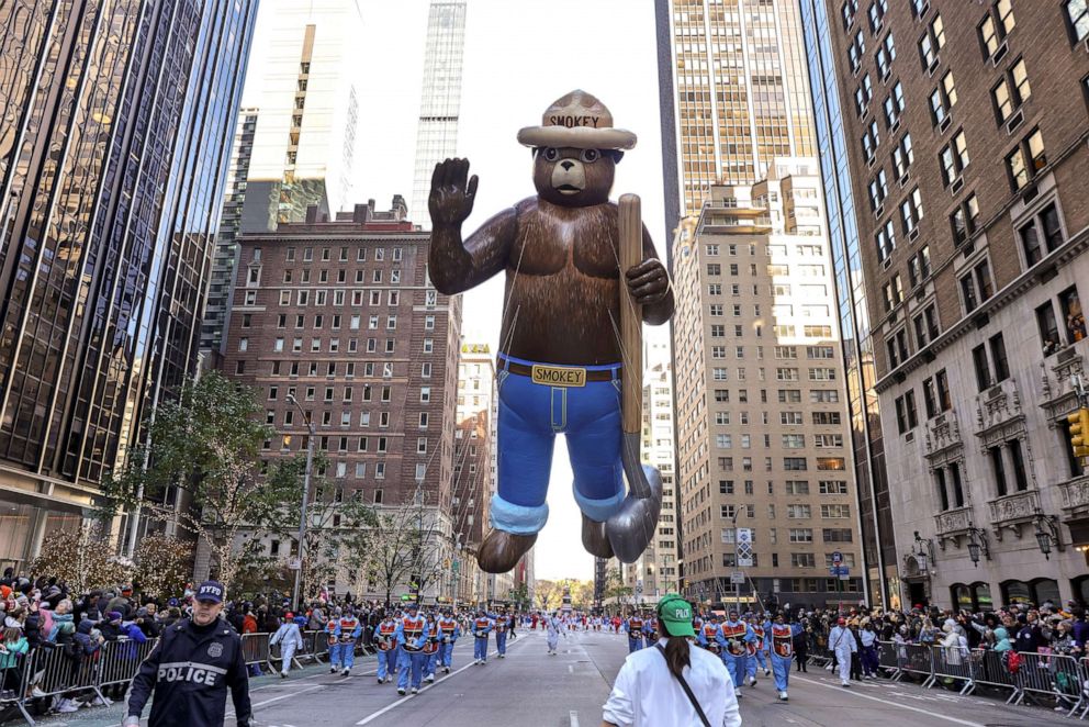 PHOTO: Handlers pull the Smokey Bear balloon down Sixth Avenue during the Macy's Thanksgiving Day Parade, Nov. 24, 2022, in New York. 