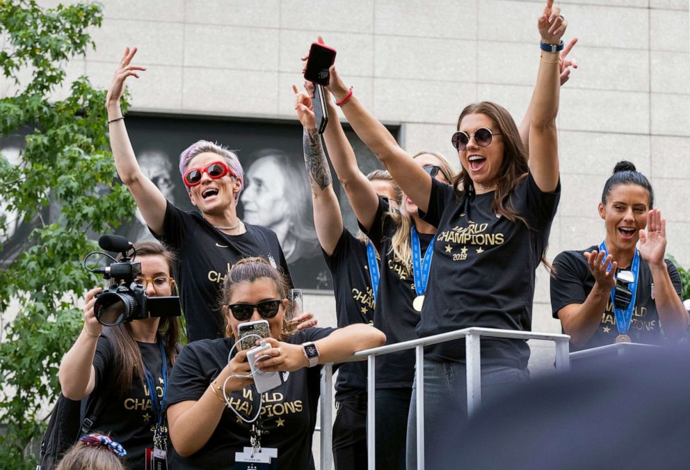 PHOTO:Members of the U.S. women's soccer team, including Megan Rapinoe, left, and Alex Morgan, right, stand on a float before being honored with a ticker tape parade along the Canyon of Heroes in New York, July 10, 2019.
