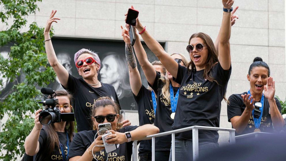 PHOTO: Member of the U.S. women's soccer team, including Megan Rapinoe,left, and Alex Morgan, right, stand on a float before being honored with a ticker tape parade along the Canyon of Heroes, July 10, 2019, in New York.