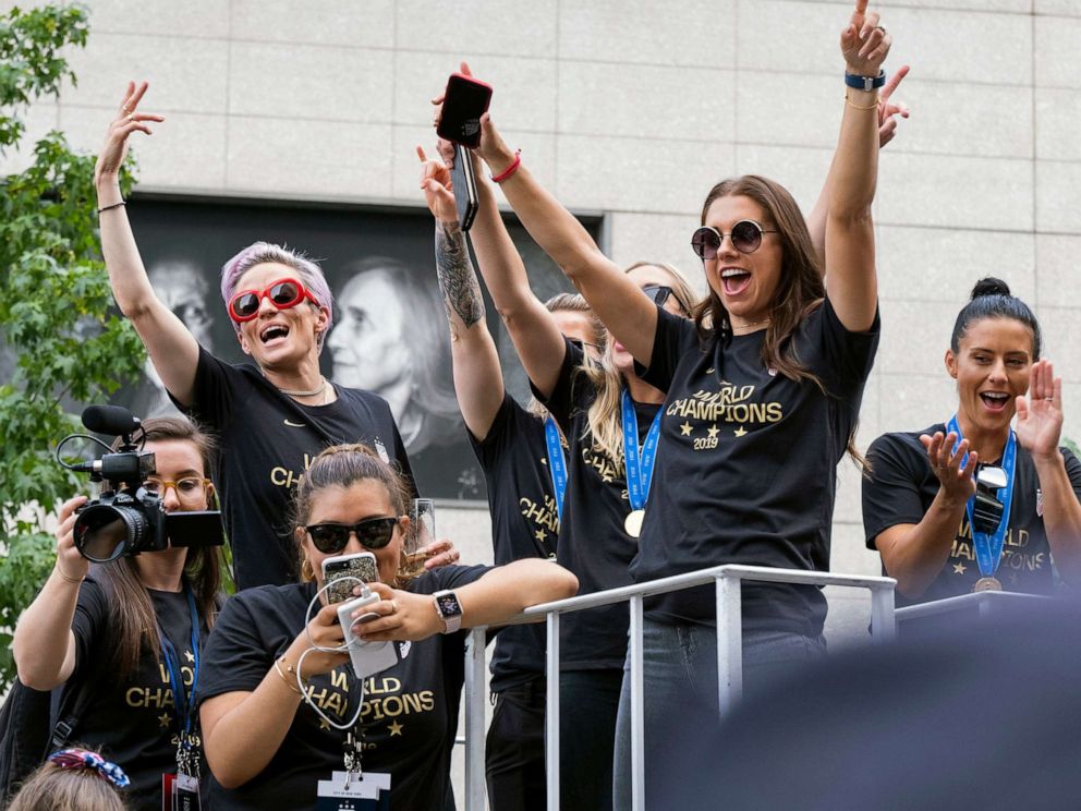 PHOTO: Member of the U.S. womens soccer team, including Megan Rapinoe,left, and Alex Morgan, right, stand on a float before being honored with a ticker tape parade along the Canyon of Heroes, July 10, 2019, in New York.