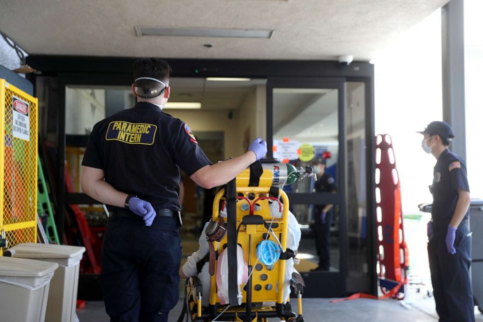 PHOTO: Paramedics wait to bring a patient into the emergency room at Regional Medical Center in San Jose, California, on May 21, 2020.