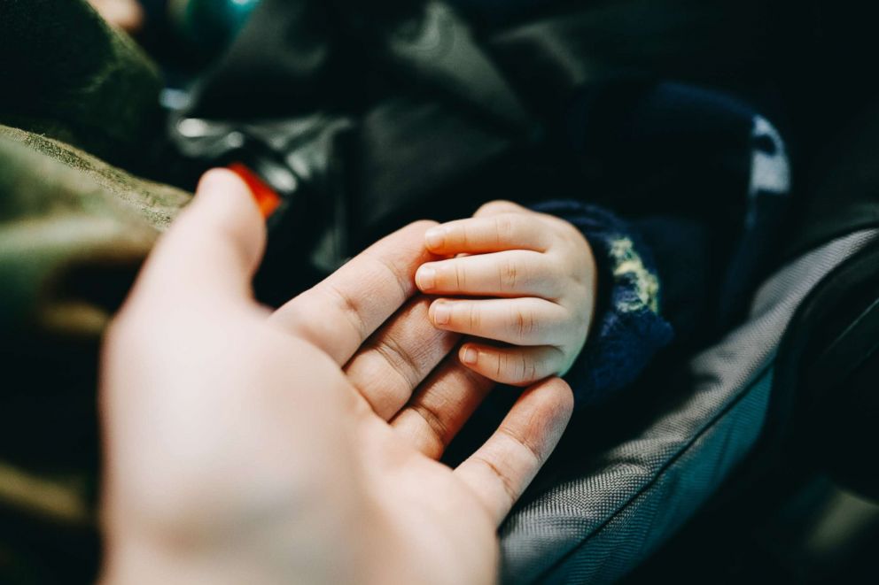 PHOTO: A father holds his baby's hand in this undated stock photo.