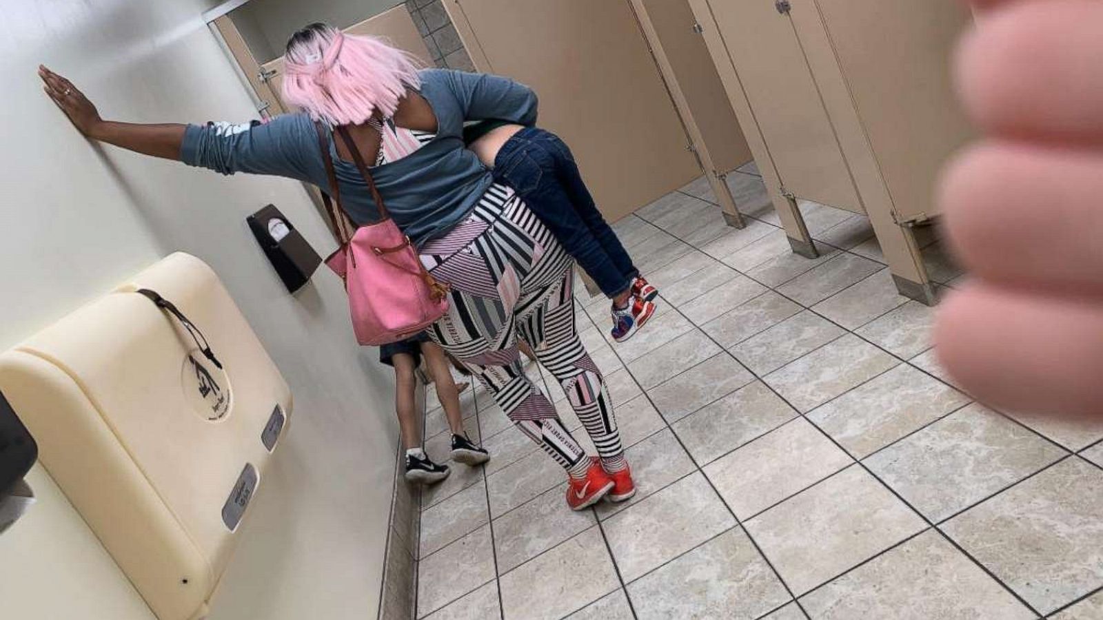 PHOTO: A mother in Texas was seen inside the bathroom of a Hobby Lobby store making her child do pushups.