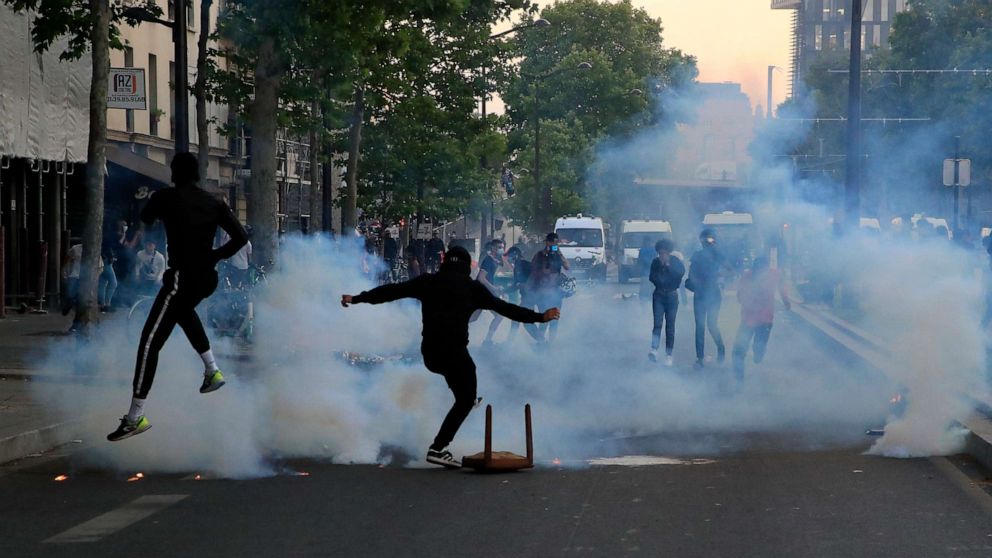 PHOTO: Protester kick in tear gas canisters during a demonstration Tuesday, June 2, 2020 in Paris.
