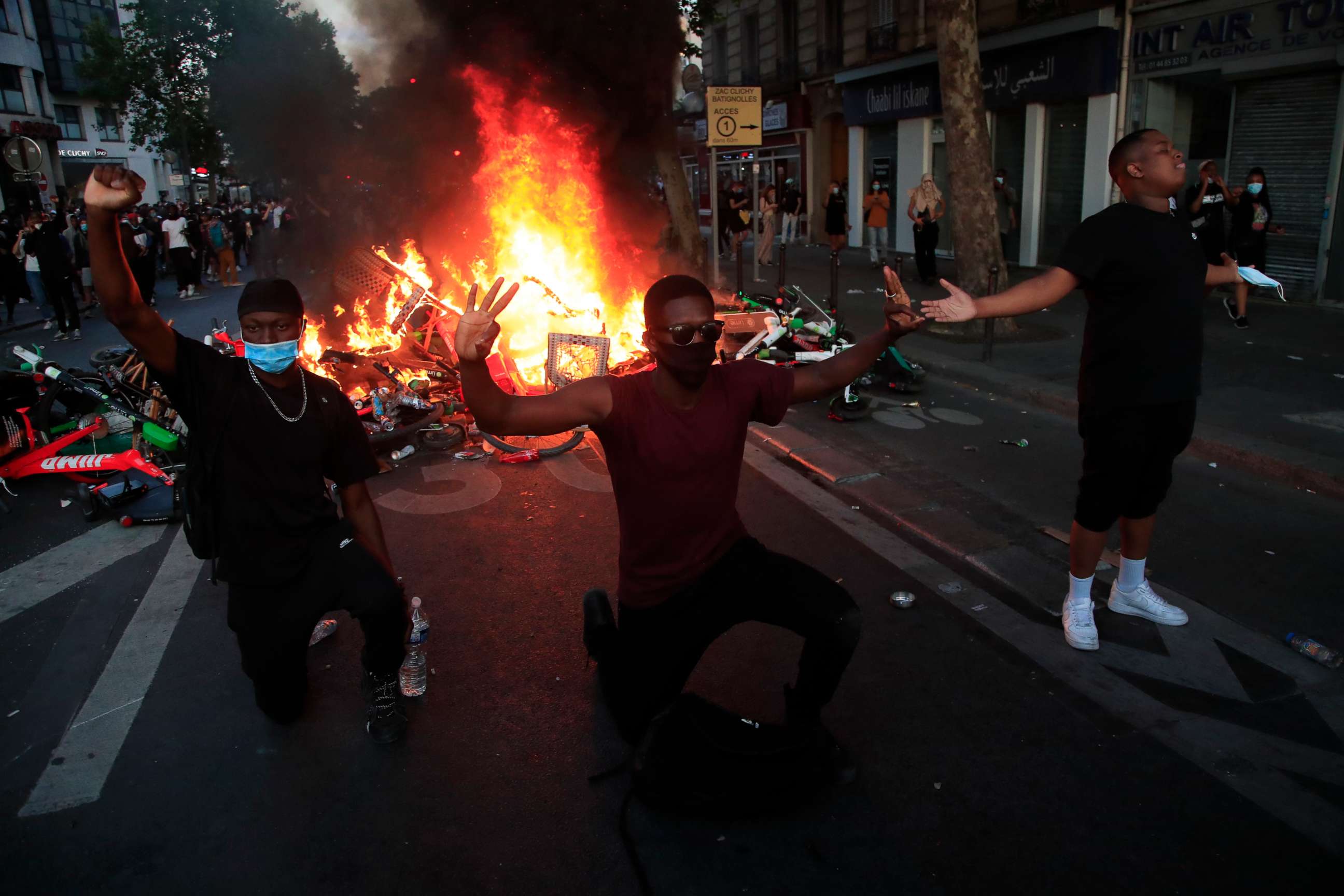 PHOTO: Protesters kneel and react by a burning barricade during a demonstration Tuesday, June 2, 2020 in Paris.
