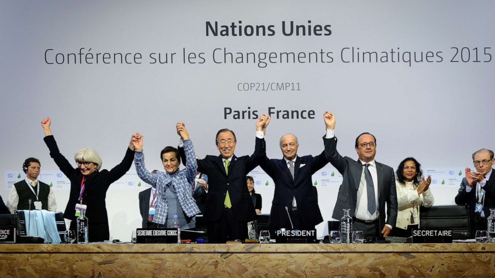 PHOTO: Executive Secretary of the United Nations Framework Convention on Climate Change (UNFCCC) raise hands together after adoption of a historic global warming pact at the COP21 Climate Conference in Le Bourget, north of Paris, Dec. 12, 2015.
