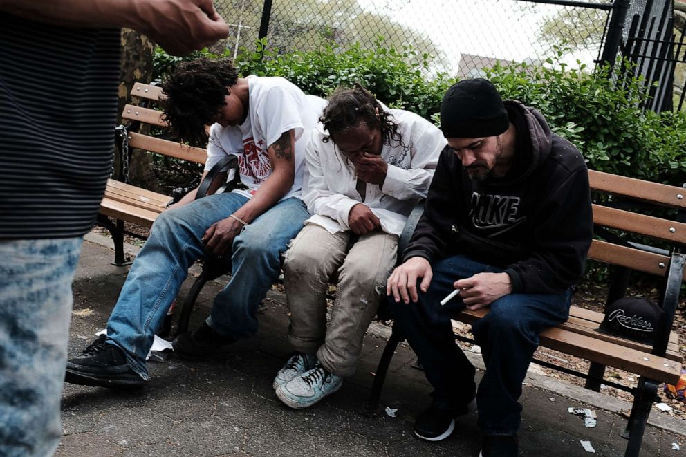 PHOTO: Men sit passed out in a park where heroin users gather to shoot up in the Bronx borough of New York, May 4, 2018.