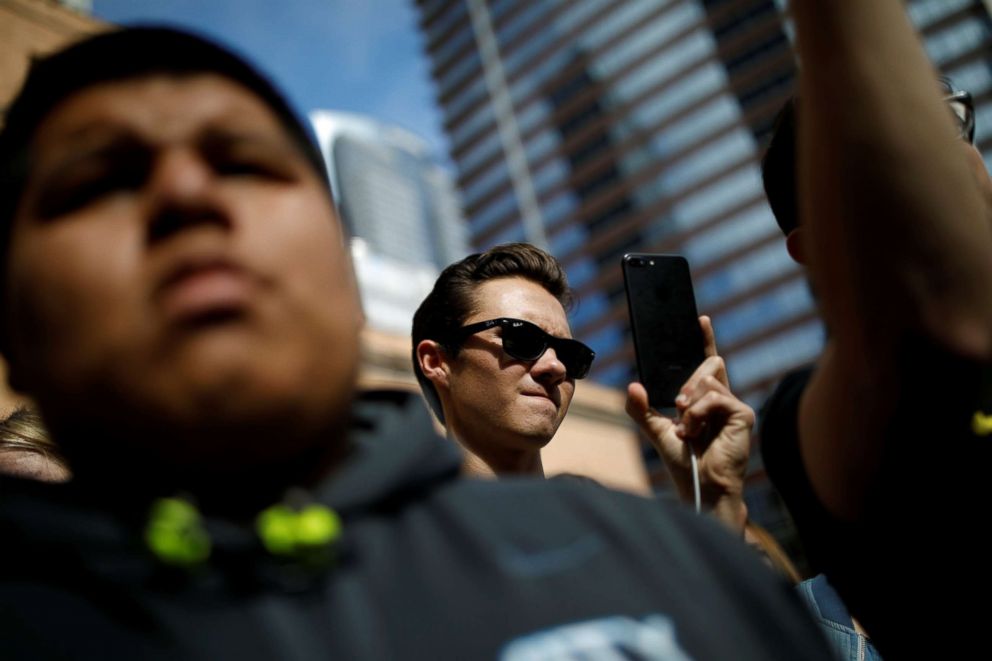 PHOTO: David Hogg, a shooting survivor from Marjory Stoneman Douglas High School looks on as Manuel Oliver, the father of Joaquin Oliver, paints a mural to commemorate the victims and promote gun control, April 7, 2018.