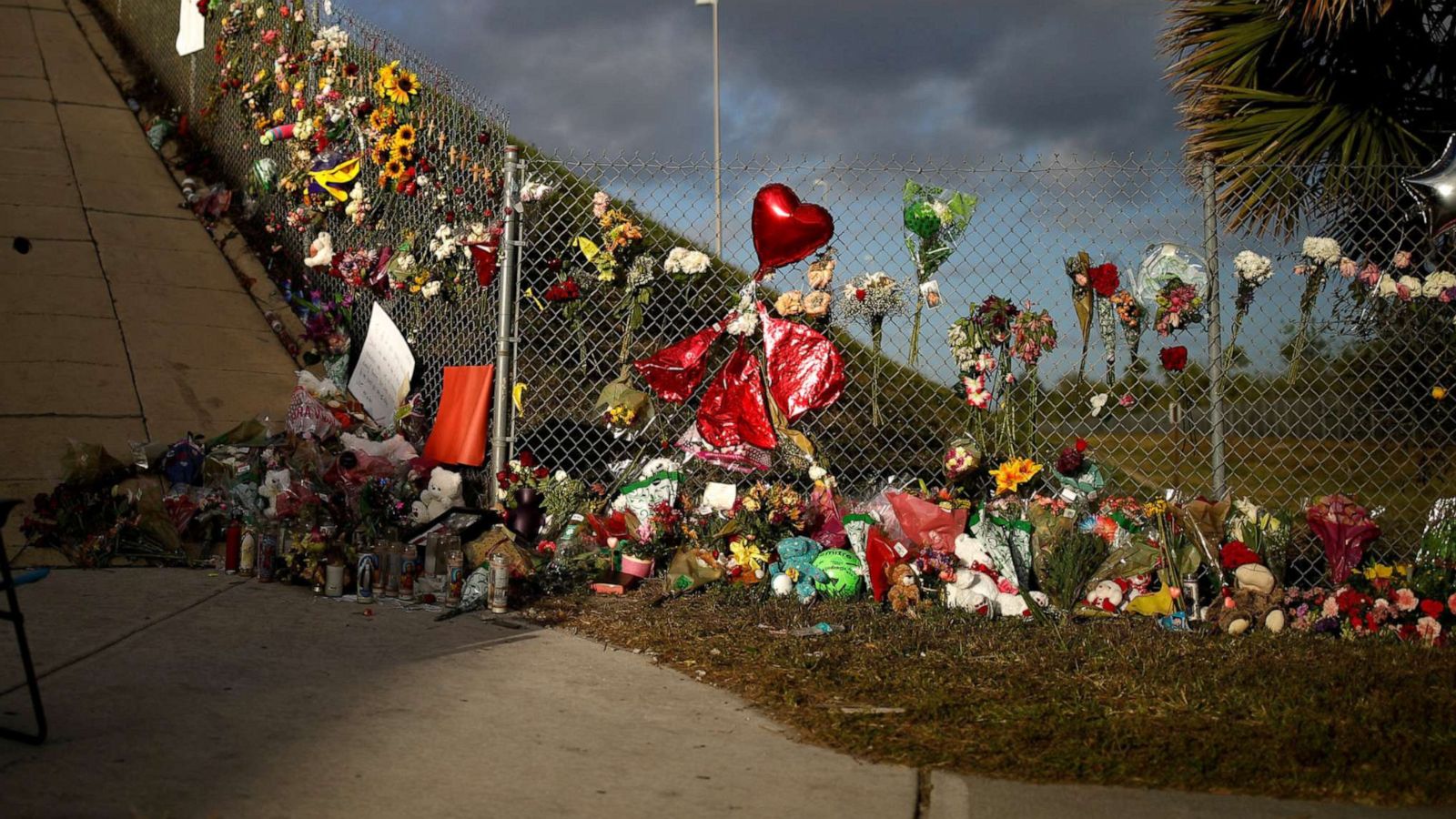 PHOTO: An empty chair is seen in front of flowers and mementos placed on a fence to commemorate the victims of the mass shooting at Marjory Stoneman Douglas High School, in Parkland, Fla., Feb. 20, 2018.