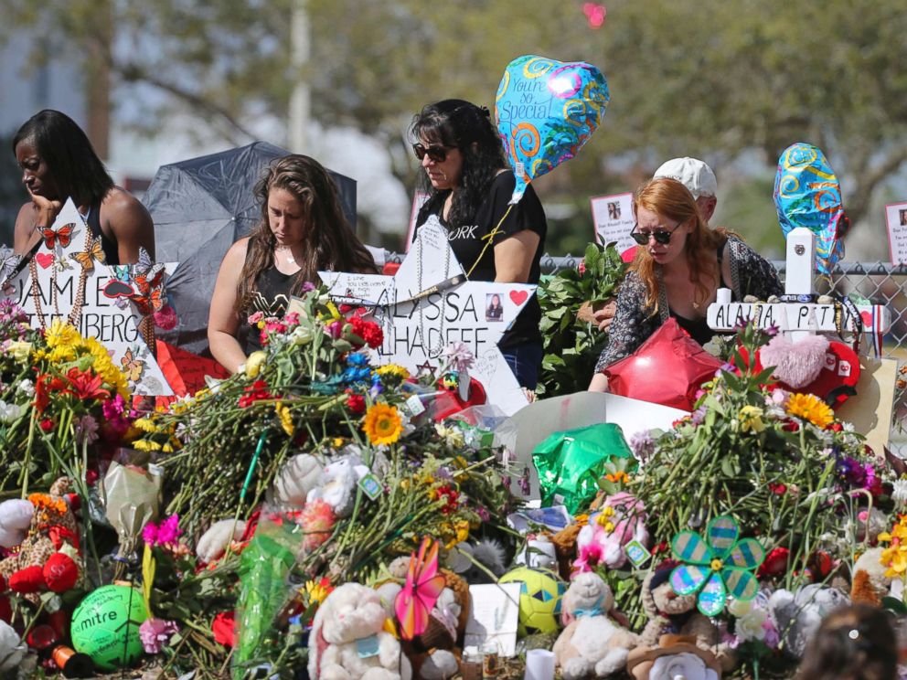PHOTO: Mourners bring flowers as they pay tribute at a memorial for the victims of the shooting at Marjory Stoneman Douglas High School, Feb. 25, 2018, in Parkland, Fla.