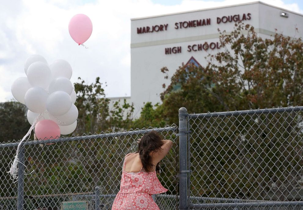 PHOTO: Angela Tanner, rests against the fence that surrounds the Marjory Stoneman Douglas High School, Feb. 18, 2018 in Parkland, Fla.