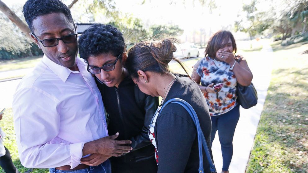 Family members embrace after a student walked out from Marjory Stoneman Douglas High School, Feb. 14, 2018, in Parkland, Fla.