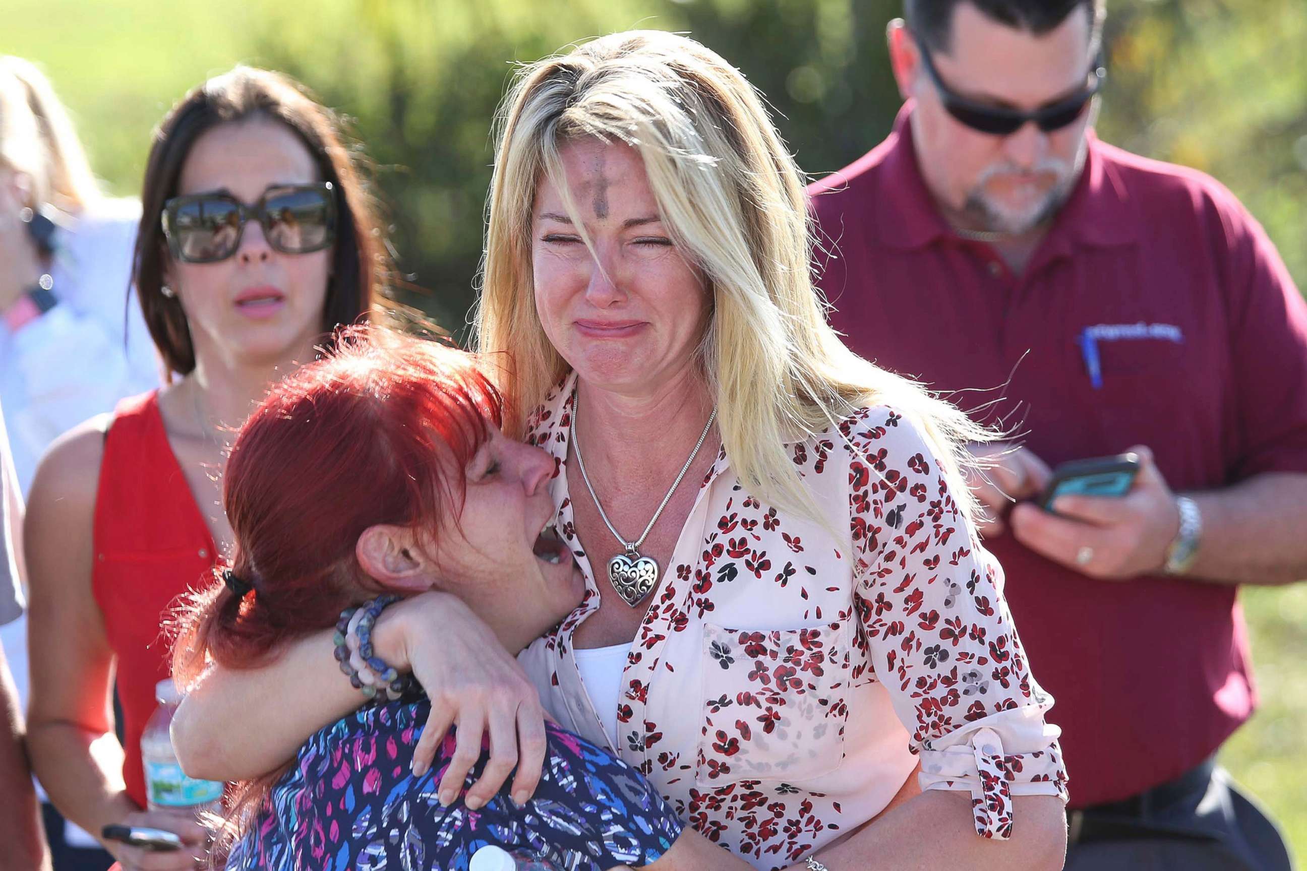 PHOTO: Women embrace in a waiting area for parents of students after a shooting at Marjory Stoneman Douglas High School in Parkland, Fla., Feb. 14, 2018.