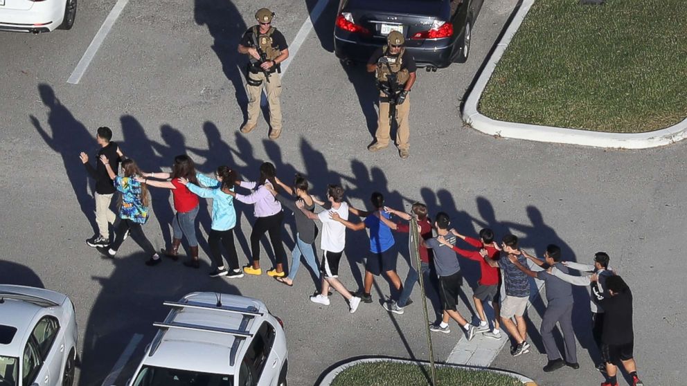 PHOTO: People are brought out of the Marjory Stoneman Douglas High School after a shooting at the school on Feb. 14, 2018 in Parkland, Fla.