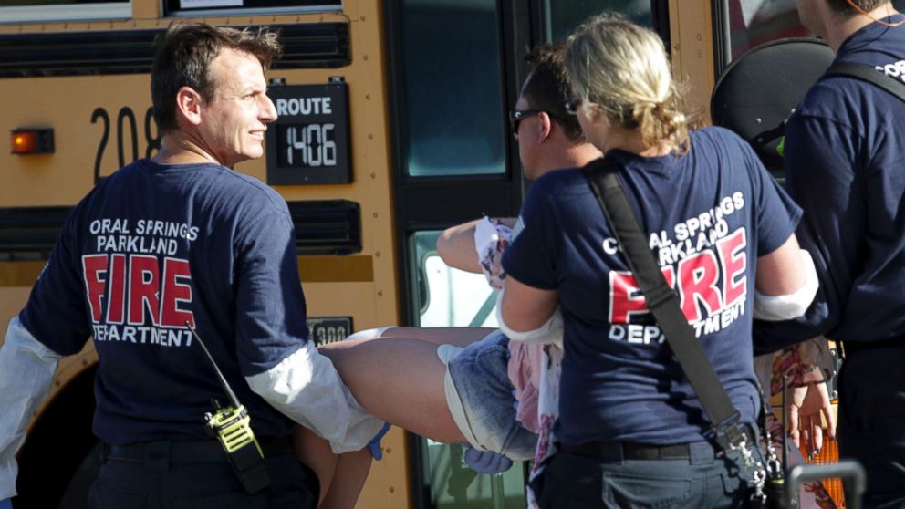 Medical personnel tend to a victim following a shooting at Marjory Stoneman Douglas High School in Parkland, Fla., on Feb. 14, 2018.