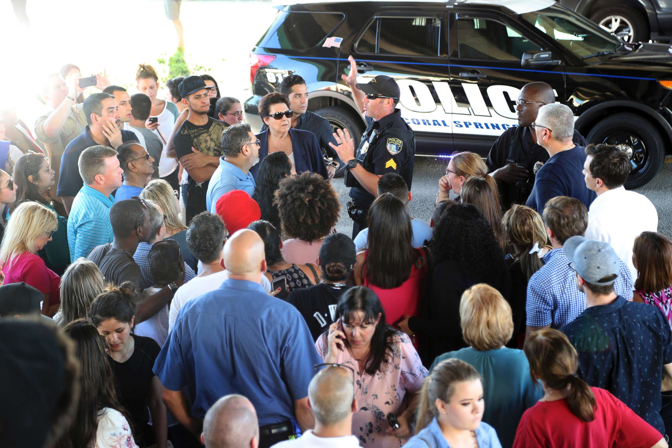 PHOTO: A police officer gives instructions to parents waiting to meet up with their kids following a shooting at Marjory Stoneman Douglas High School in Parkland, Fla., Feb. 14, 2018.