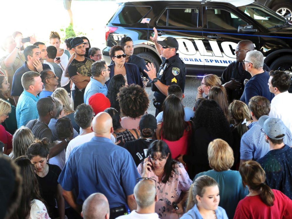 PHOTO: A police officer gives instructions to parents waiting to meet up with their kids following a shooting at Marjory Stoneman Douglas High School in Parkland, Fla., Feb. 14, 2018.