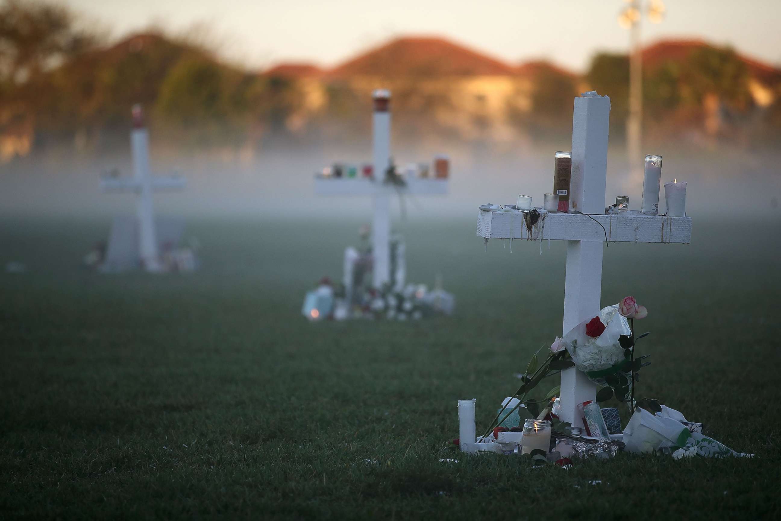 PHOTO: Candles that were placed on crosses still glow after last nights vigil for victims of the mass shooting at Marjory Stoneman Douglas High School, at Pine Trail Park, Feb. 16, 2018, in Parkland, Fla. 