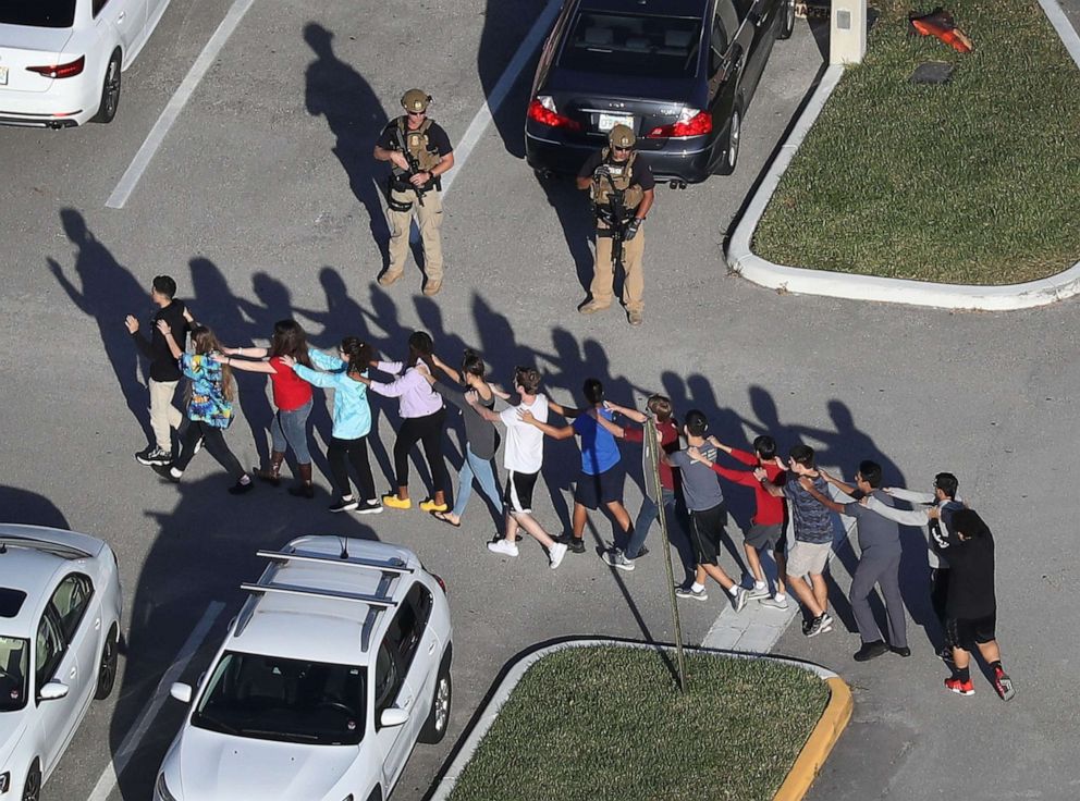 PHOTO: People are brought out of the Marjory Stoneman Douglas High School after a shooting at the school, Feb. 14, 2018 in Parkland, Florida.