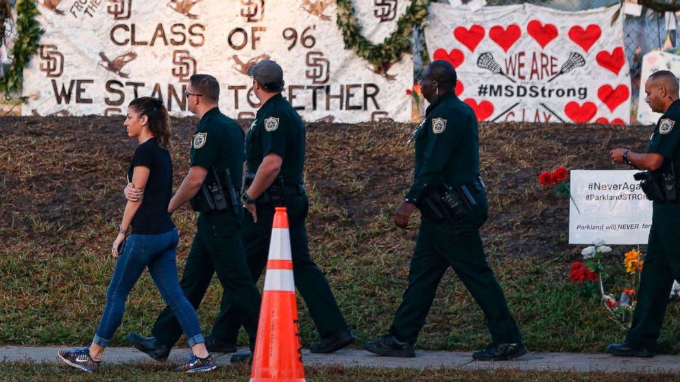 Marjory Stoneman Douglas High School staff, teachers and students return to school greeted by police and well wishers in Parkland, Fla. Feb. 28, 2018.