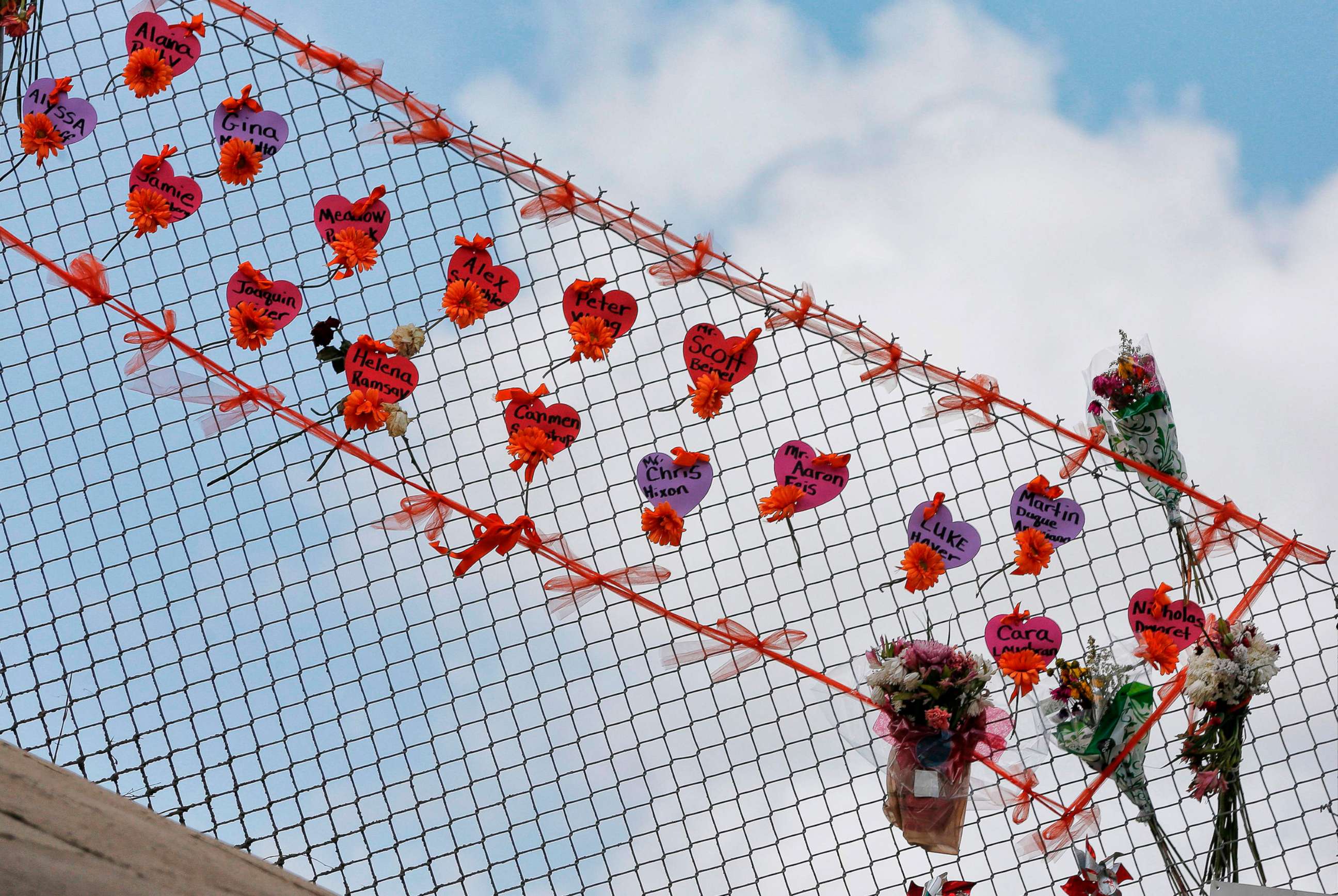 PHOTO: Memorials are seen on a fence surrounding Marjory Stoneman Douglas High School in Parkland, Florida on Feb. 21, 2018.
