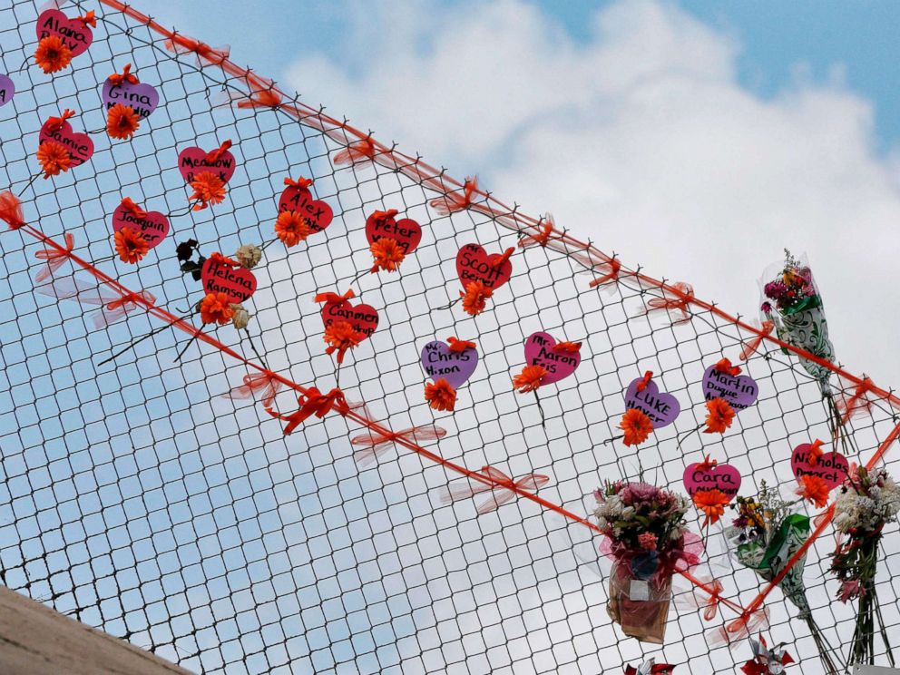 PHOTO: Memorials are seen on a fence surrounding Marjory Stoneman Douglas High School in Parkland, Florida on Feb. 21, 2018.
