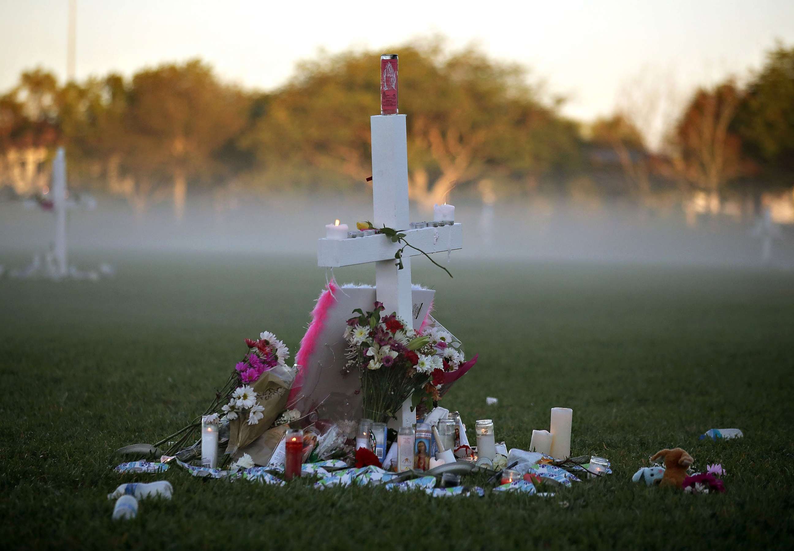 PHOTO:FILE PHOTO: Candles rest on a cross after a nighttime vigil for victims of the Feb. 14, 2018 mass shooting at Marjory Stoneman Douglas High School, at Pine Trail Park, on Feb. 16, in Parkland, Fla.