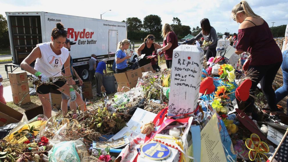 Volunteers, students and parents sort items left at the memorial site for the 17 students and faculty killed at Marjory Stoneman Douglas High School, March 28, 2018 in Parkland, Fla.