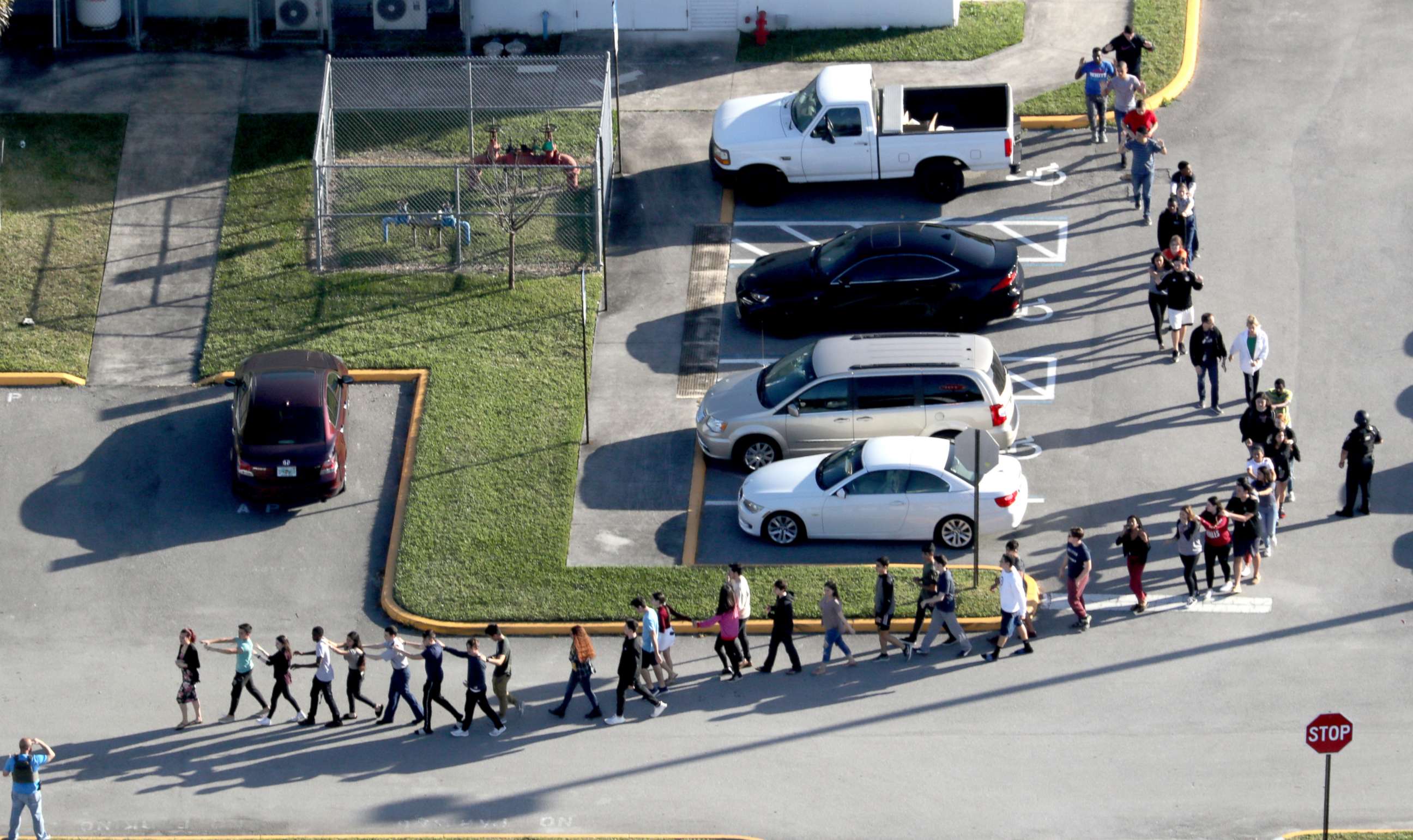 PHOTO: Students are evacuated by police out of Stoneman Douglas High School in Parkland, Fla., after a shooting, Feb. 14, 2018.