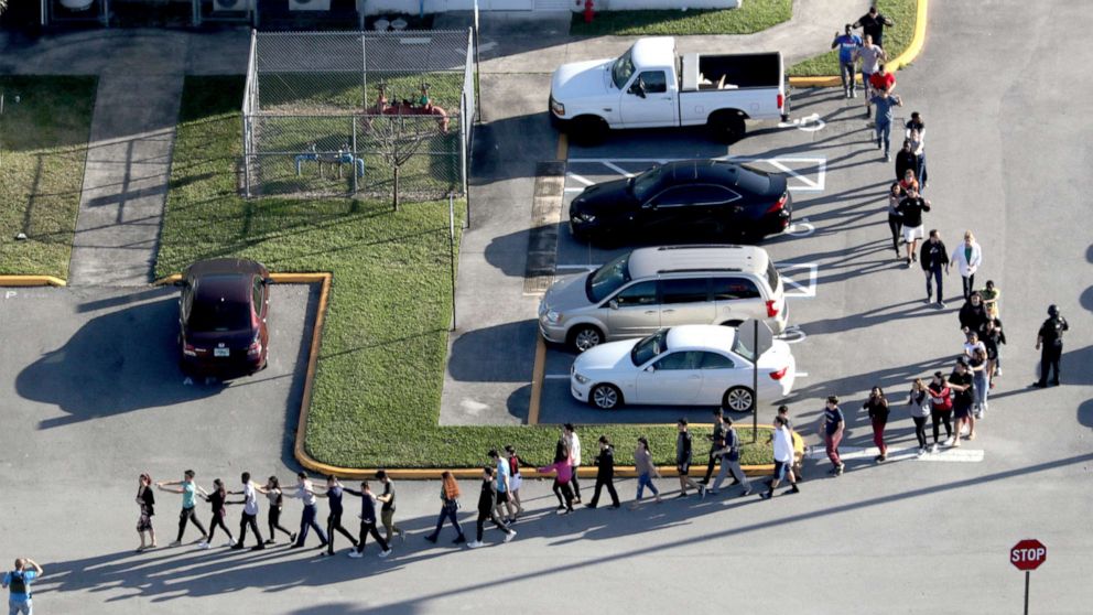 PHOTO: Students are evacuated by police out of Stoneman Douglas High School in Parkland, Fla., after a shooting, Feb. 14, 2018.
