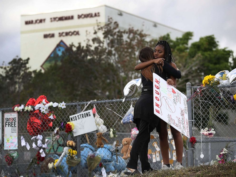 PHOTO: Tyra Heman, right, a senior at Marjory Stoneman Douglas High School, is hugged by Rachael Buto in front of the school where 17 people were killed in a mass shooting, Feb. 19, 2018 in Parkland, Fla.