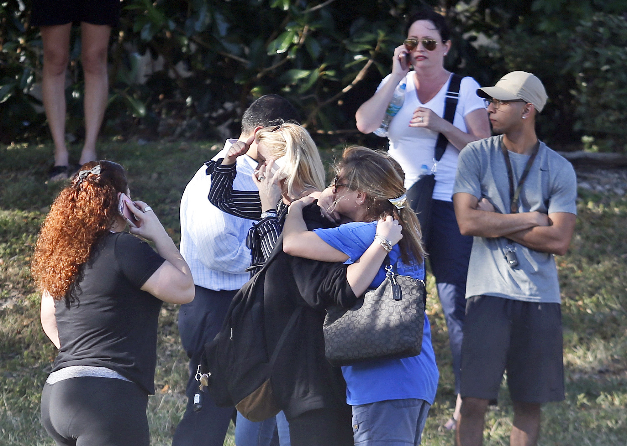 PHOTO: Anxious family members wait for news of students as two people embrace, Feb. 14, 2018, in Parkland, Fla. 