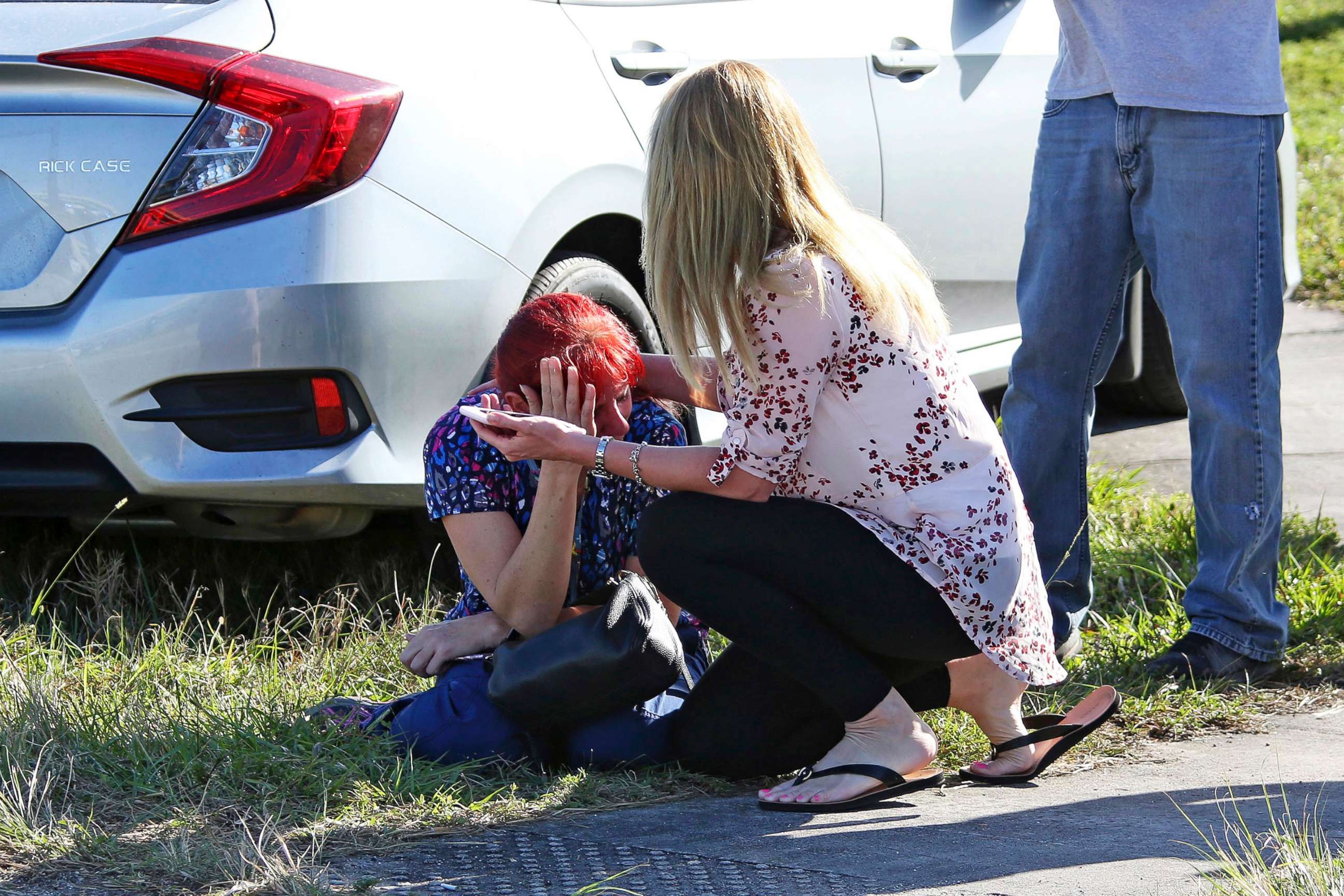 PHOTO: A woman consoles another as parents wait for news regarding a shooting at Marjory Stoneman Douglas High School in Parkland, Fla., Feb. 14, 2018.