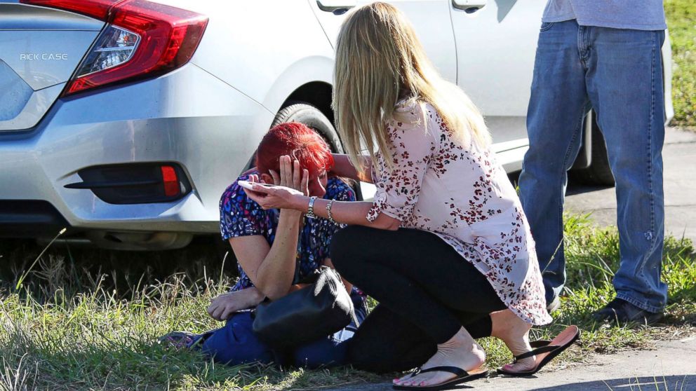 PHOTO: A woman consoles another as parents wait for news regarding a shooting at Marjory Stoneman Douglas High School in Parkland, Fla., Feb. 14, 2018.