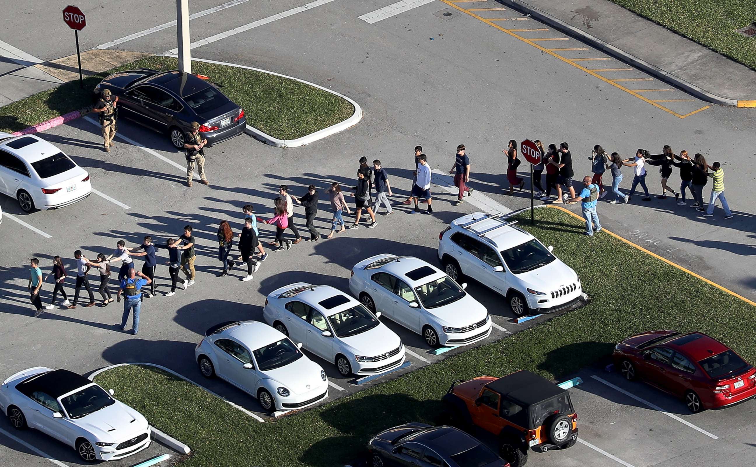 PHOTO: People are brought out of the Marjory Stoneman Douglas High School after a shooting, Feb. 14, 2018, in Parkland, Florida.