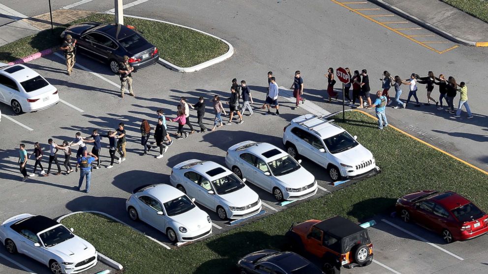 People are brought out of the Marjory Stoneman Douglas High School after a shooting at the school that reportedly killed and injured multiple people on Feb. 14, 2018 in Parkland, Fla. 