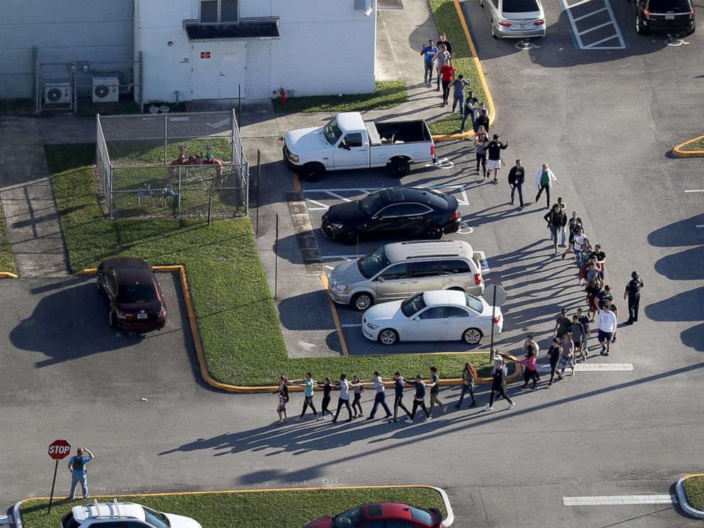 PHOTO: People are brought out of the Marjory Stoneman Douglas High School after a shooting, Feb. 14, 2018, in Parkland, Florida.