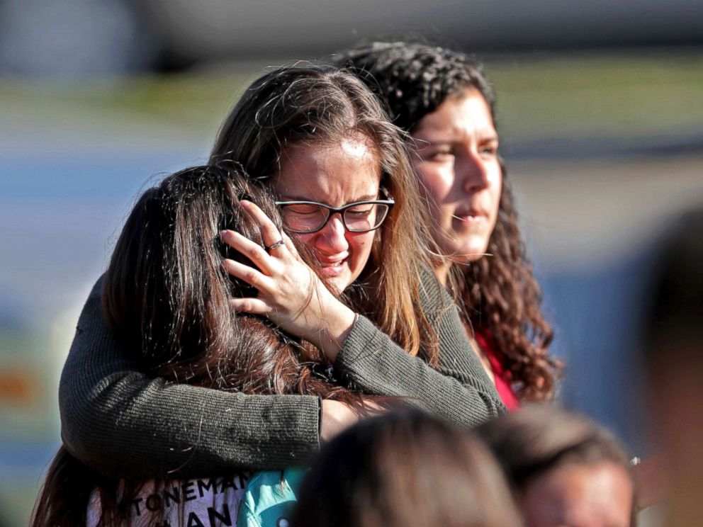 PHOTO: Students released from a lockdown embrace following a shooting at Marjory Stoneman Douglas High School in Parkland, Fla., Feb. 14, 2018.