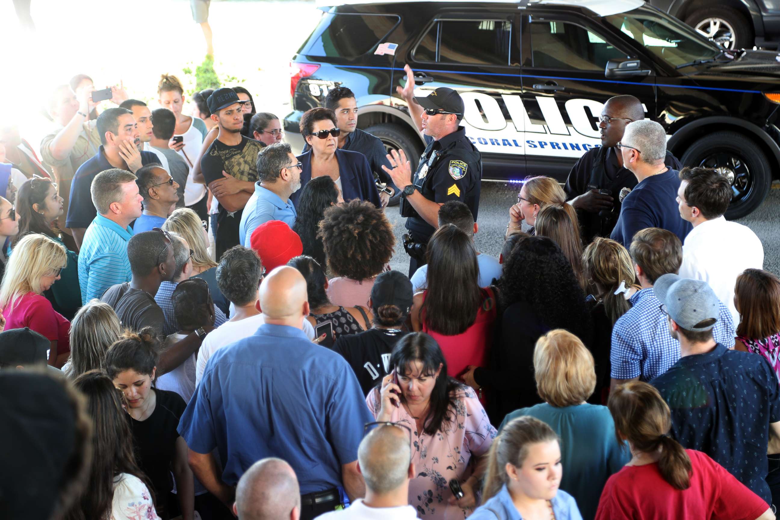 PHOTO: An officer talks to parents of students from Stoneman Douglas High School in Parkland, Fla., after a shooting on Feb. 14, 2018.
