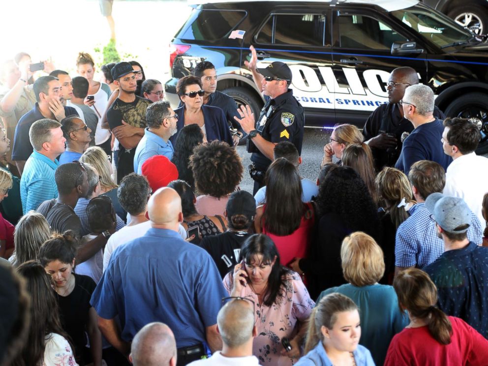 PHOTO: An officer talks to parents of students from Stoneman Douglas High School in Parkland, Fla., after a shooting on Feb. 14, 2018.