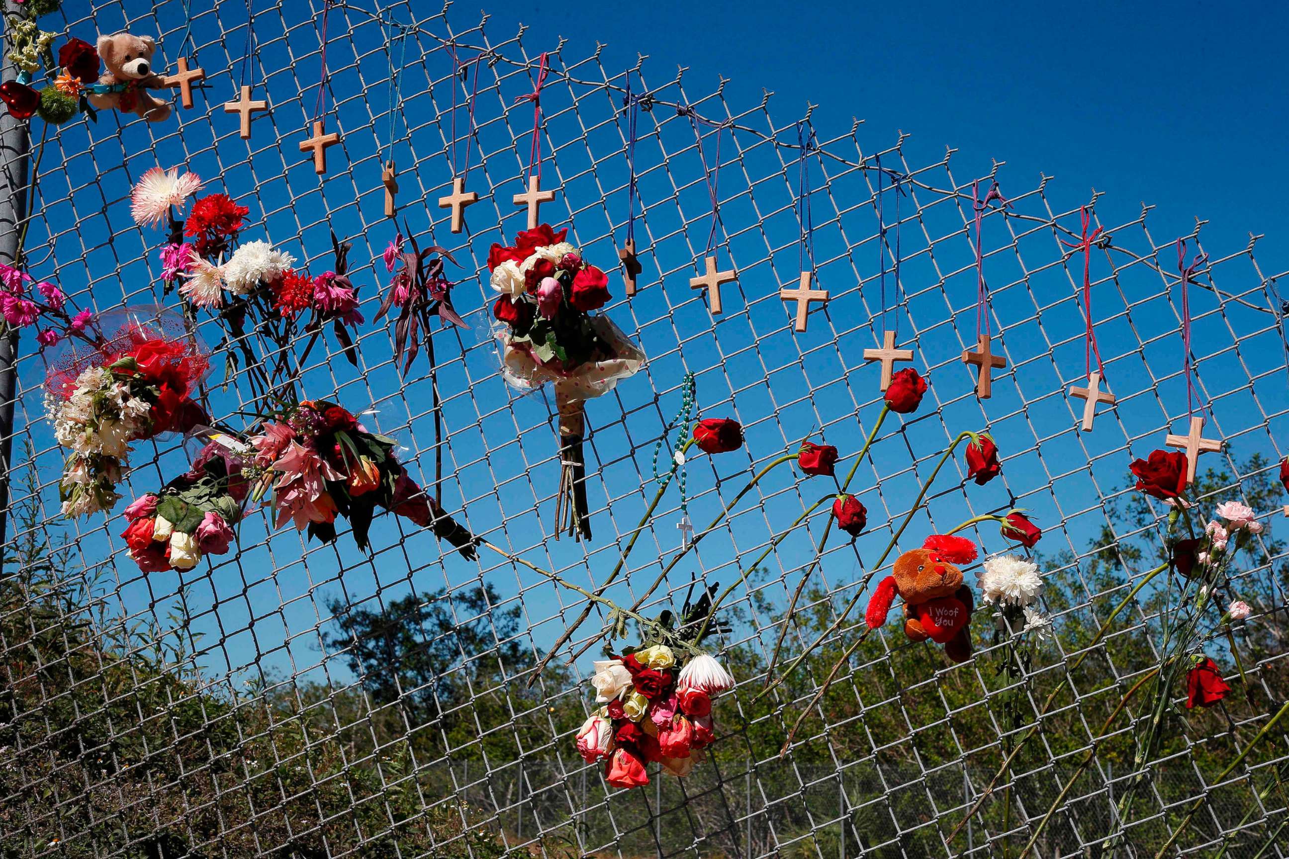 PHOTO: Flowers and crosses line a fence near the school on a makeshift memorial for the victims of the Marjory Stoneman Douglas High School shooting in Parkland, Fla., Feb. 16, 2018.
