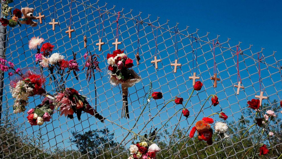 PHOTO: Flowers and crosses line a fence near the school on a makeshift memorial for the victims of the Marjory Stoneman Douglas High School shooting in Parkland, Fla., Feb. 16, 2018.