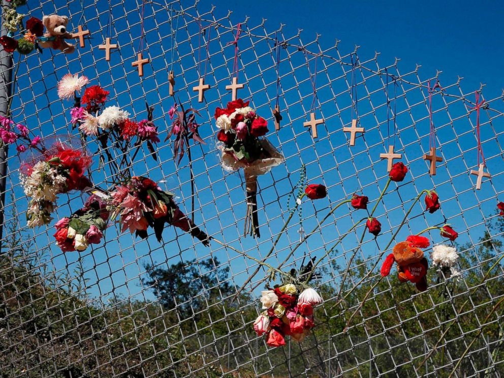PHOTO: Flowers and crosses line a fence near the school on a makeshift memorial for the victims of the Marjory Stoneman Douglas High School shooting in Parkland, Fla., Feb. 16, 2018.