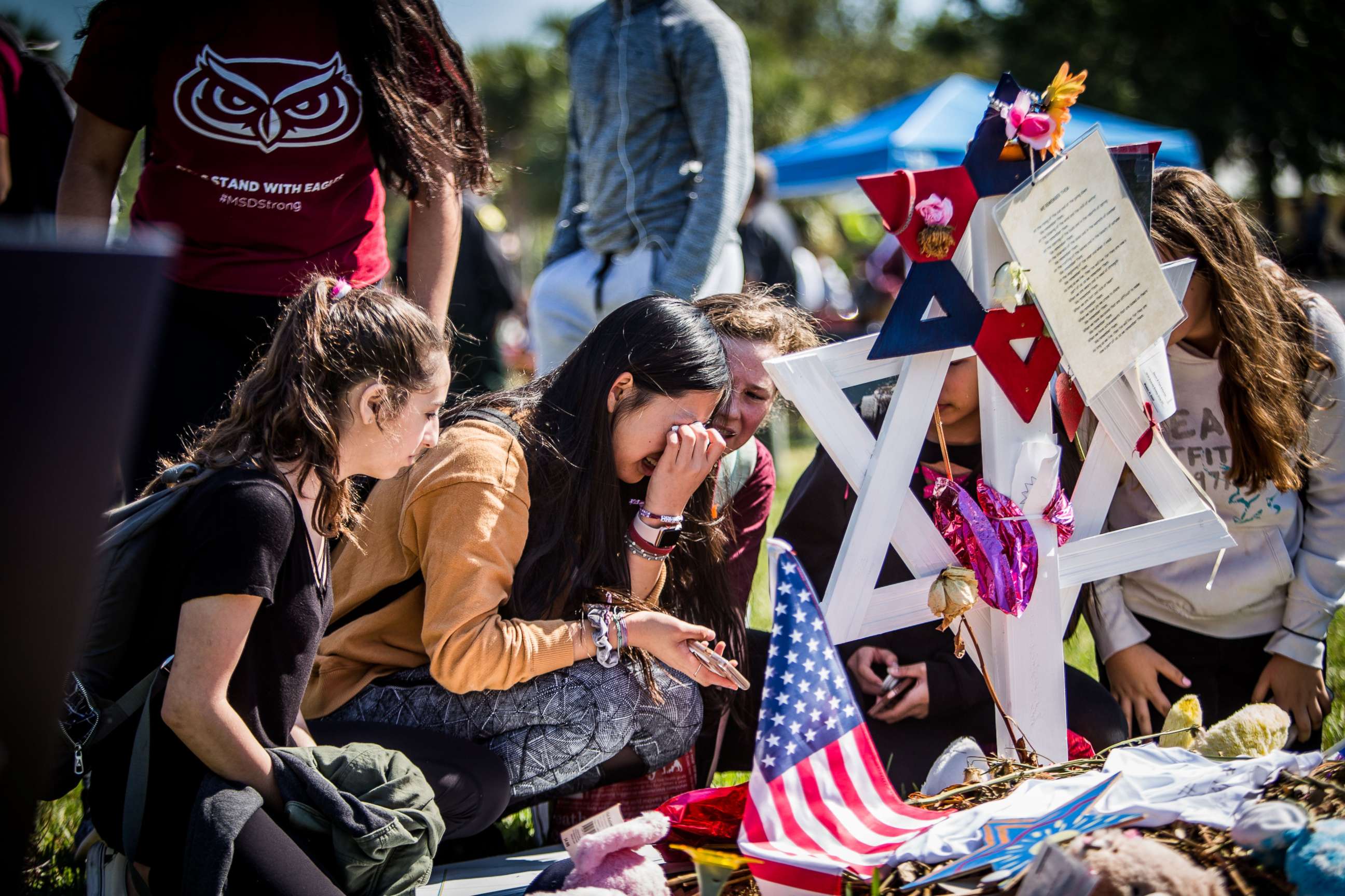 PHOTO: Students visit the memorials of their friends at Marjory Stoneman Douglas High School in Parkland, Fla., following the walkouts on March 14, 2018.