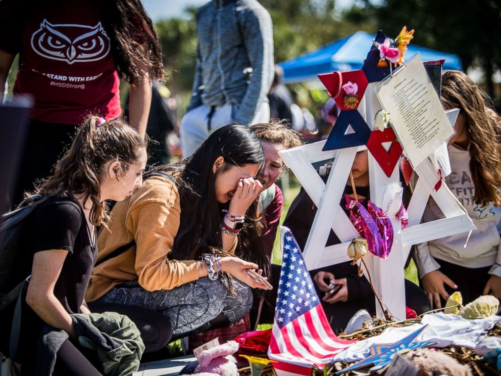 PHOTO: Students visit the memorials of their friends at Marjory Stoneman Douglas High School in Parkland, Fla., following the walkouts on March 14, 2018.