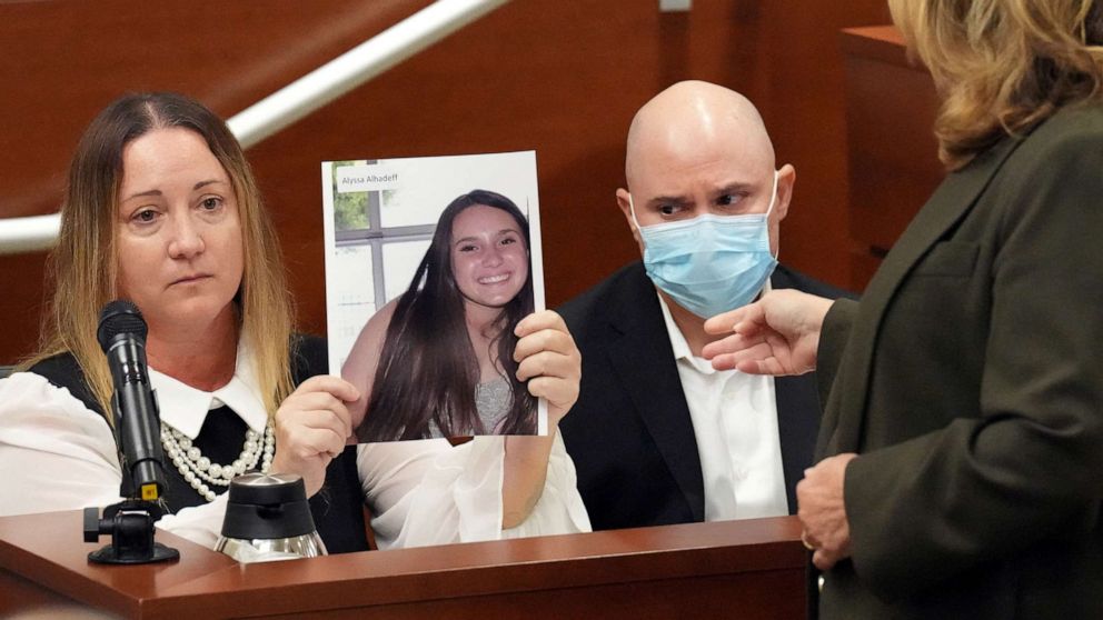 PHOTO: Lori Alhadeff holds a photograph of her daughter, Alyssa, as she and her husband, Ilan Alhadeff, give their victim impact statements during the penalty phase of the trial Nikolas Cruz at the Broward in Fort Lauderdale, Fla., Aug. 2, 2022.