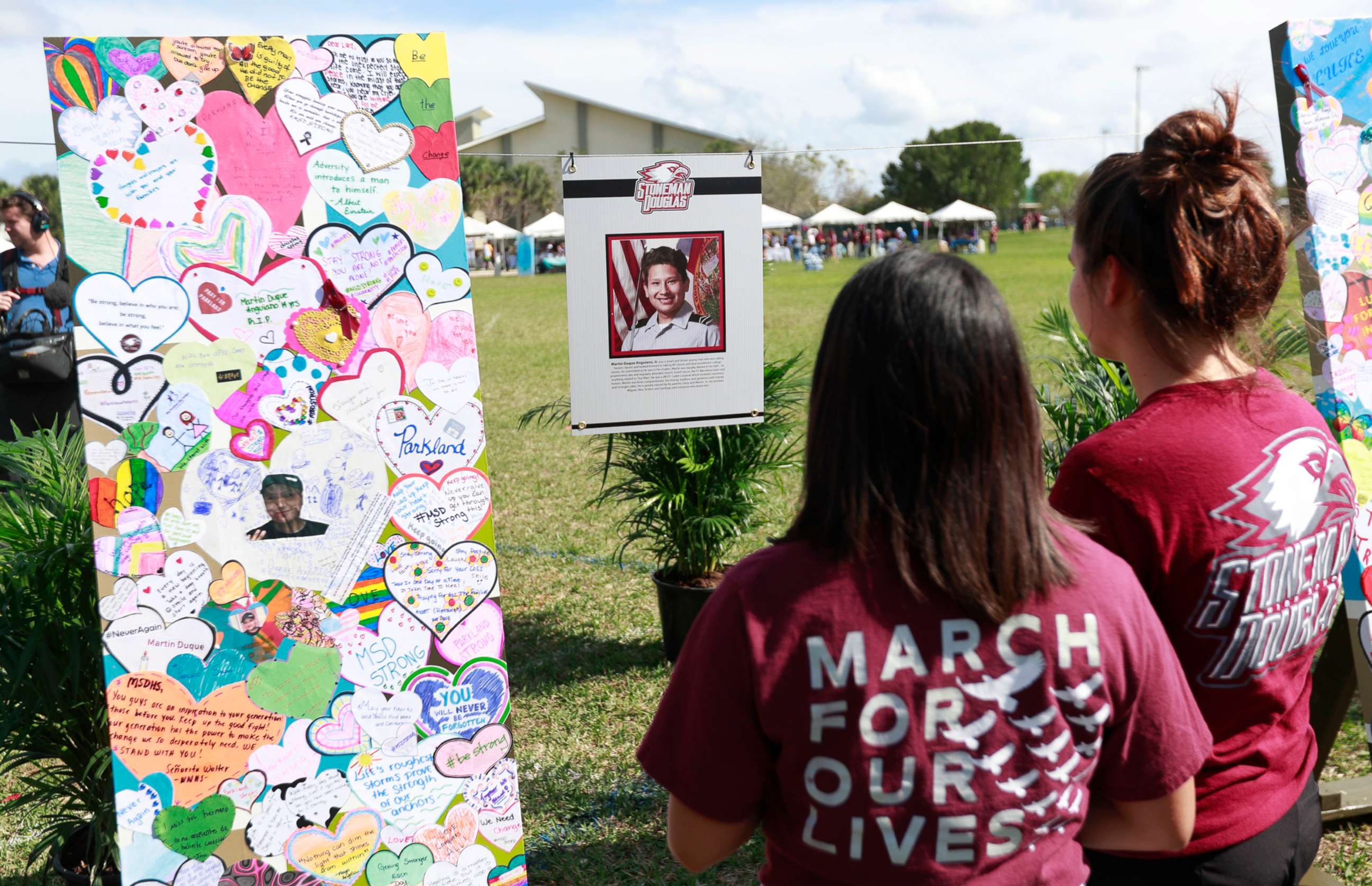 PHOTO: Attendees at Trails End Park look at  memorial for Martin Duque Anguiano, one of the 17 that was killed during the Marjory Stoneman Douglas High School shooting in Parkland, Fla., Feb. 14, 2019. 